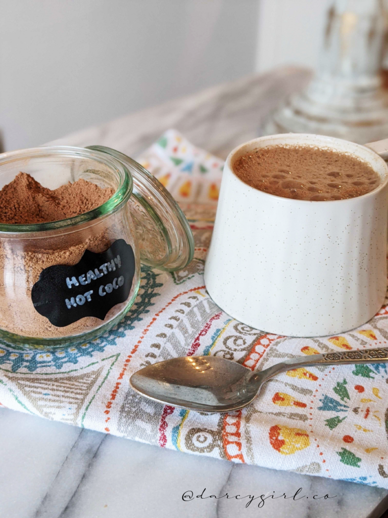 hot chocolate powder and a mug of hot chocolate.