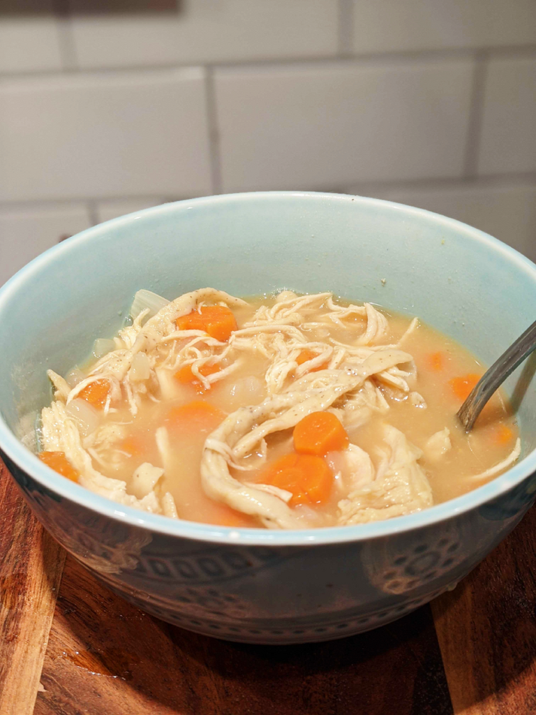 Chicken noodle soup with carrots.