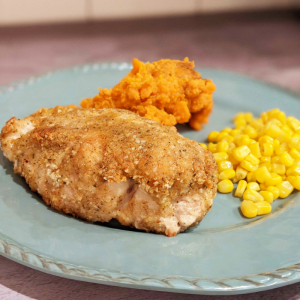 Fried chicken, yams, corn on a plate