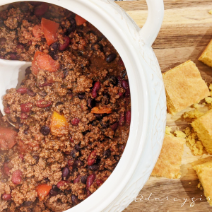 Bowl of chili with cornbread on the side,