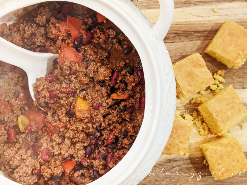 Bowl of chili with cornbread on the side