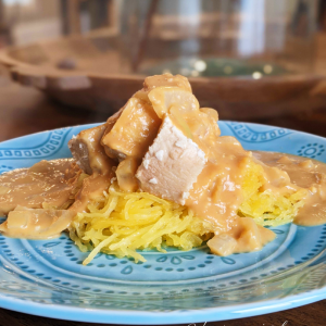 dairy-free pumpkin alfredo over shredded spaghetti square and chicken on top