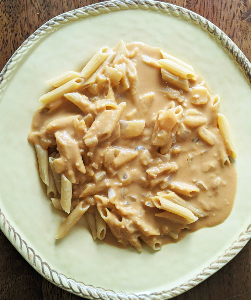 Dairy-free pumpkin alfredo sauce over penne pasta.  